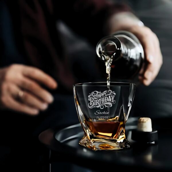 PREMIUM DESIGN: Elegant crystal whiskey glass with unique geometric base pattern and personalised engraving for a sophisticated drinking experience CUSTOMISATION: Features decorative 'Happy Birthday' text with space for personalised name and date engraving CONSTRUCTION: Made from high-quality crystal glass that offers exceptional clarity and brilliant refraction of light VERSATILE USE: Perfect for serving whiskey, scotch, bourbon, or other premium spirits with a capacity suitable for standard pours DIMENSIONS: Distinctive twisted base design with substantial weight and stability for comfortable handling