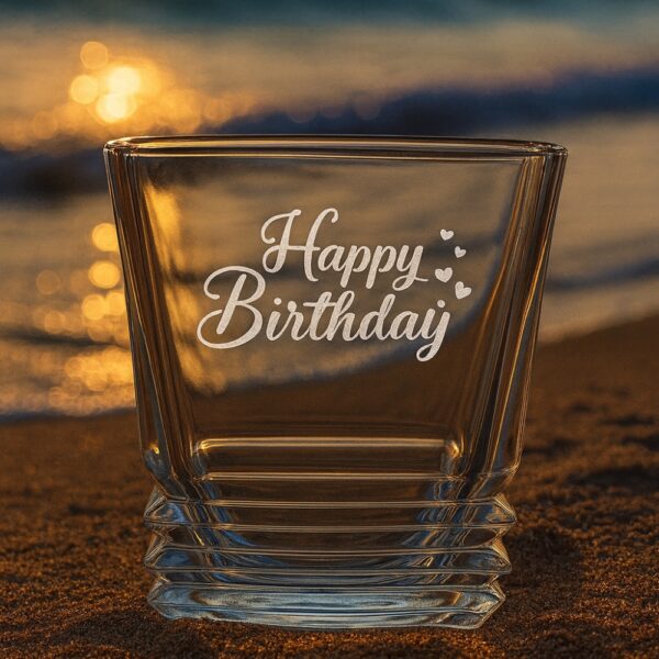 Personalized crystal whiskey glass with engraved “Happy Birthday” message, custom name Shidharth, filled with whiskey and ice cubes – unique engraved gift for birthdays and special occasions.