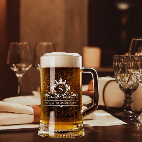Elevate your drinking experience with this exquisite 500ml personalised beer mug, featuring an elegant crown monogram design. The crystal-clear glass construction showcases your favourite brew while adding a touch of sophistication with its beautifully engraved pattern. Perfect as a thoughtful gift for special occasions, this sturdy mug combines classic styling with personalised charm. The comfortable handle provides a secure grip, whilst the generous 500ml capacity ensures ample room for your preferred beverage. The premium quality glass material preserves your drink's temperature and carbonation, making every sip as enjoyable as the first. Whether it's for Christmas, birthdays, or any celebration, this customised beer mug makes for a memorable present that's both practical and stylish. The intricate crown design and monogram add a royal touch to this drinking vessel, making it a cherished addition to any collection. Suitable for various beverages, this mug promises to be a conversation starter at gatherings and a treasured keepsake for years to come.