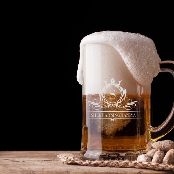 Elevate your drinking experience with this exquisite 500ml personalised beer mug, featuring an elegant crown monogram design. The crystal-clear glass construction showcases your favourite brew while adding a touch of sophistication with its beautifully engraved pattern. Perfect as a thoughtful gift for special occasions, this sturdy mug combines classic styling with personalised charm. The comfortable handle provides a secure grip, whilst the generous 500ml capacity ensures ample room for your preferred beverage. The premium quality glass material preserves your drink's temperature and carbonation, making every sip as enjoyable as the first. Whether it's for Christmas, birthdays, or any celebration, this customised beer mug makes for a memorable present that's both practical and stylish. The intricate crown design and monogram add a royal touch to this drinking vessel, making it a cherished addition to any collection. Suitable for various beverages, this mug promises to be a conversation starter at gatherings and a treasured keepsake for years to come.