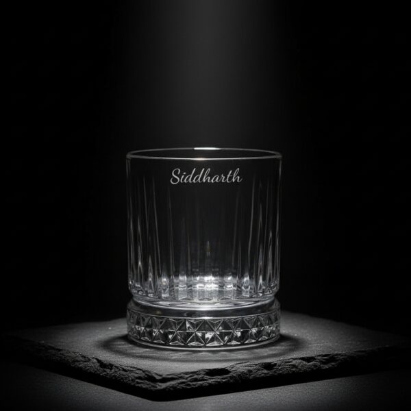 Best2U Personalized Crystal Whiskey Glass with custom name engraving “Siddharth.” This 330ml glass features a sophisticated vertical line pattern and a diamond-cut base that reflects light elegantly. Crafted from premium crystal, the glass combines clarity and durability, making it ideal for whiskey, scotch, or bourbon. The deep engraving ensures the name remains permanent, while the classic design enhances any home bar setting.
