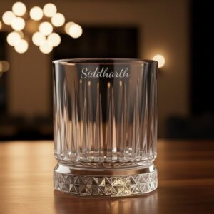 Best2U Personalized Crystal Whiskey Glass with custom name engraving “Siddharth.” This 330ml glass features a sophisticated vertical line pattern and a diamond-cut base that reflects light elegantly. Crafted from premium crystal, the glass combines clarity and durability, making it ideal for whiskey, scotch, or bourbon. The deep engraving ensures the name remains permanent, while the classic design enhances any home bar setting.