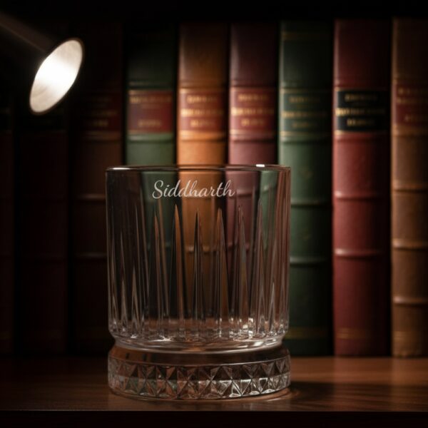 Best2U Personalized Crystal Whiskey Glass with custom name engraving “Siddharth.” This 330ml glass features a sophisticated vertical line pattern and a diamond-cut base that reflects light elegantly. Crafted from premium crystal, the glass combines clarity and durability, making it ideal for whiskey, scotch, or bourbon. The deep engraving ensures the name remains permanent, while the classic design enhances any home bar setting.