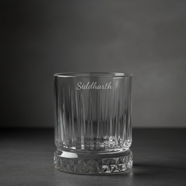 Best2U Personalized Crystal Whiskey Glass with custom name engraving “Siddharth.” This 330ml glass features a sophisticated vertical line pattern and a diamond-cut base that reflects light elegantly. Crafted from premium crystal, the glass combines clarity and durability, making it ideal for whiskey, scotch, or bourbon. The deep engraving ensures the name remains permanent, while the classic design enhances any home bar setting.