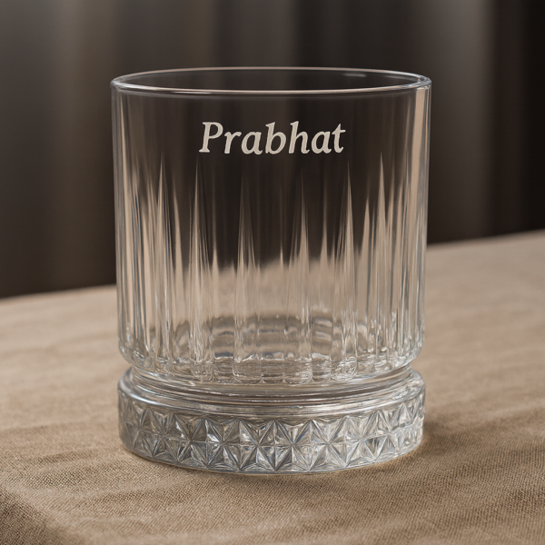 Personalized engraved whiskey glass with name 'Prabhat' on the side and bottom message 'I Promise to Always Be by Your Side', displayed outdoors on grass