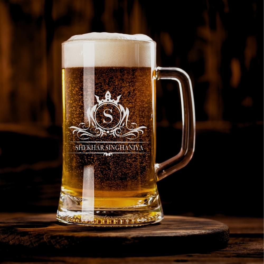 Elevate your drinking experience with this exquisite 500ml personalised beer mug, featuring an elegant crown monogram design. The crystal-clear glass construction showcases your favourite brew while adding a touch of sophistication with its beautifully engraved pattern. Perfect as a thoughtful gift for special occasions, this sturdy mug combines classic styling with personalised charm. The comfortable handle provides a secure grip, whilst the generous 500ml capacity ensures ample room for your preferred beverage. The premium quality glass material preserves your drink's temperature and carbonation, making every sip as enjoyable as the first. Whether it's for Christmas, birthdays, or any celebration, this customised beer mug makes for a memorable present that's both practical and stylish. The intricate crown design and monogram add a royal touch to this drinking vessel, making it a cherished addition to any collection. Suitable for various beverages, this mug promises to be a conversation starter at gatherings and a treasured keepsake for years to come.